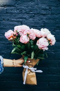 Close-up of hand holding flower bouquet