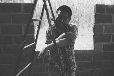 Young man standing against wall