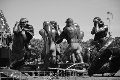 Statues in town square against clear sky