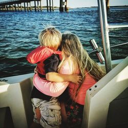 Rear view of mother and son in boat