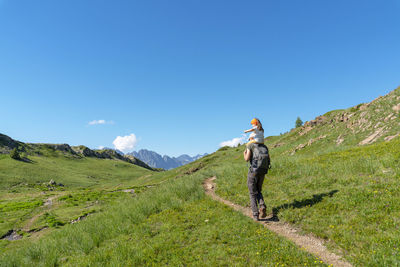 People on mountain against sky