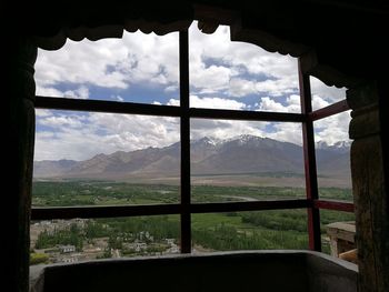 Scenic view of mountains seen through window