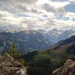 Scenic view of mountains against cloudy sky