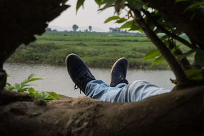 Low section of man lying on grass
