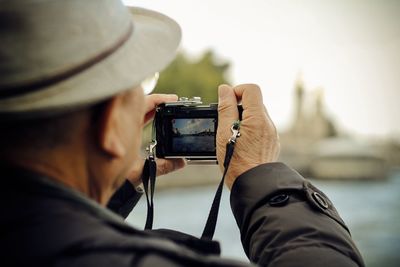 Cropped image of woman holding camera