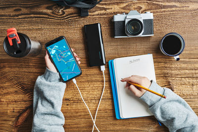 Woman planning next vacation trip while journey. girl searching destination and writing journal