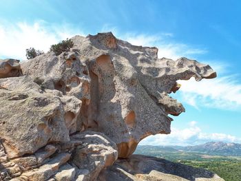 Low angle view of rock formation against sky