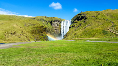 Scenic view of waterfall against sky