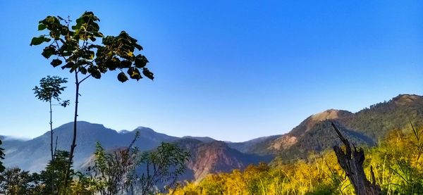 Scenic view of mountains against clear blue sky