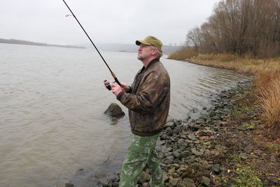 Rear view of man standing in lake