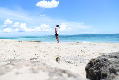 Full length of man on beach against sky