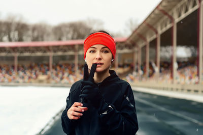 Portrait of beautiful young woman standing outdoors