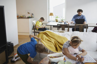 Children playing while father working from home