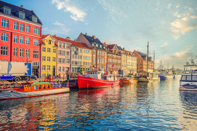 Fishing boat stands near the old small multi-colored houses in the nyhavn canal. copenhagen, denmark