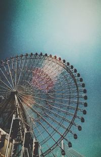 Low angle view of ferris wheel against sky