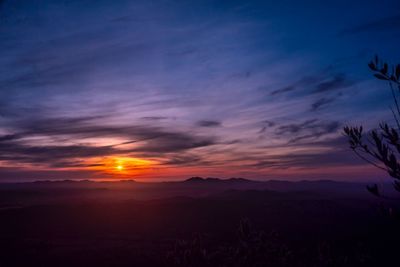 Scenic view of dramatic sky over silhouette landscape