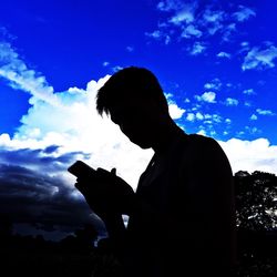 Low angle view of silhouette man against sky