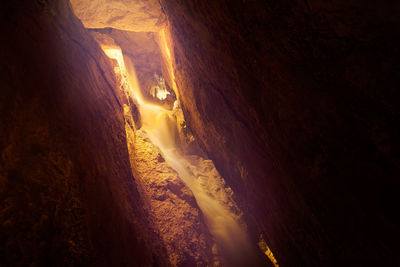 Illuminated cave at night