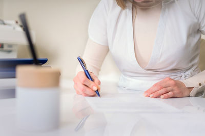 Hand of woman writing on paper