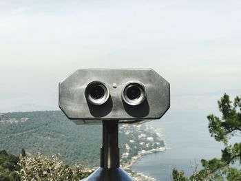 Close-up of coin-operated binoculars against clear sky