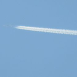 Scenic view of vapor trail against clear blue sky