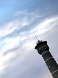 Low angle view of communications tower against building