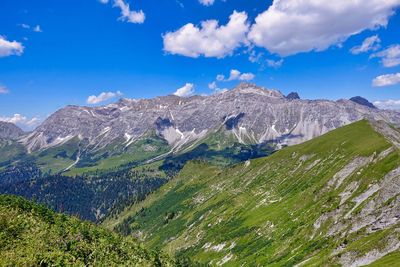 Scenic view of mountains against blue sky