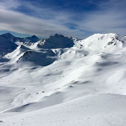 Scenic view of snow covered mountains against sky