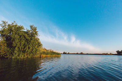 Scenic view of lake against blue sky