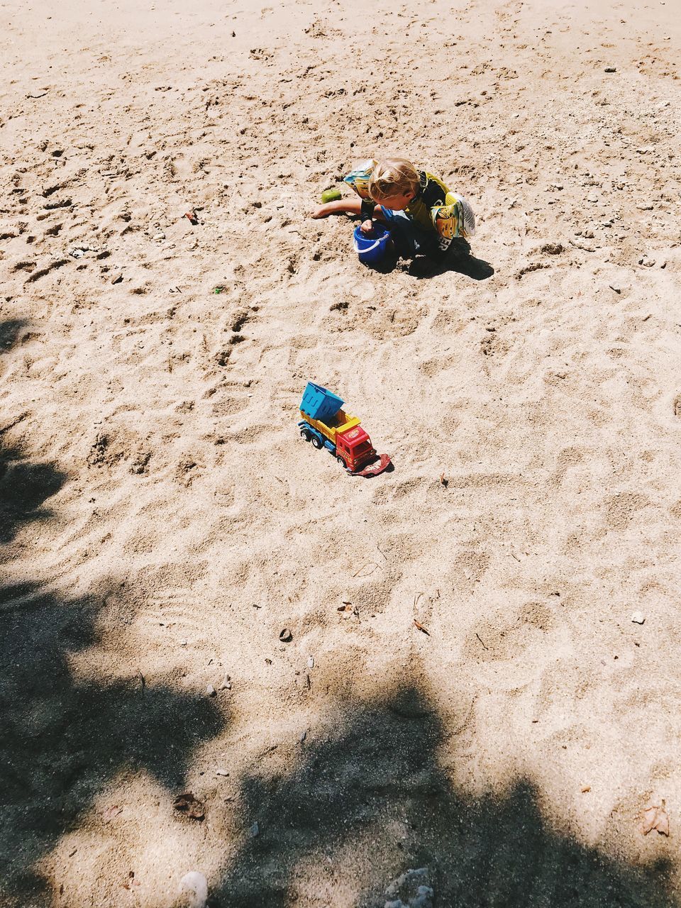 HIGH ANGLE VIEW OF MEN PLAYING WITH TOY ON BEACH