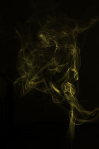 Close-up of lamp over black background