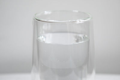 Close-up of water glass against white background