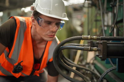 Side view of man working in factory