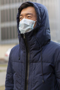 Portrait of man standing on street in city