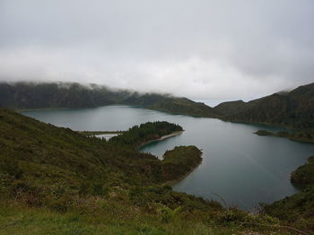 Scenic view of lake and mountains against sky