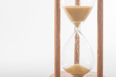 Close-up of hourglass against white background