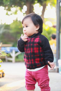 Portrait of boy standing in city