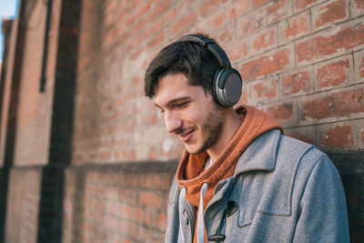 Portrait of smiling man against wall