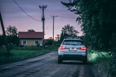 Cars on road against sky in city