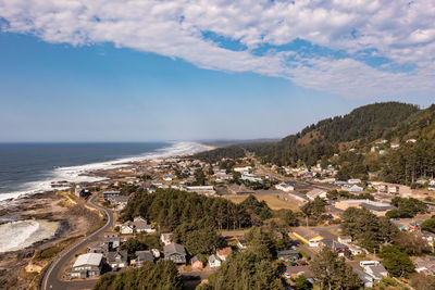 High angle view of townscape by sea against sky