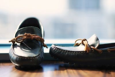 Close-up of shoes on window sill