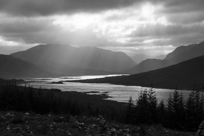 Scenic view of mountains against cloudy sky