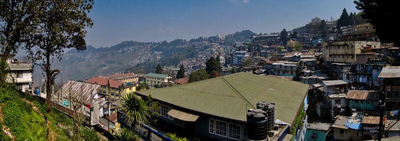 High angle view of buildings in town against sky