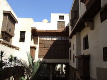 Buildings in town against clear sky