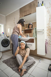 Asian beauty start their morning routine with washing and face massage in the bathroom