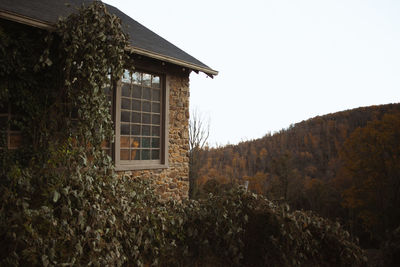 Exterior of abandoned building against clear sky