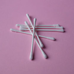 High angle view of nails on yellow background