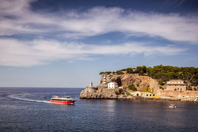 Scenic view of sea by building against sky