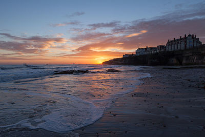 Scenic view of beach against sky during sunset