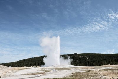 Geyser on land against sky